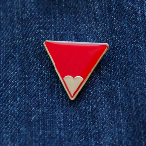 The genuine Freedom Charity Red Triangle Badge against FGM/C worn on denim
